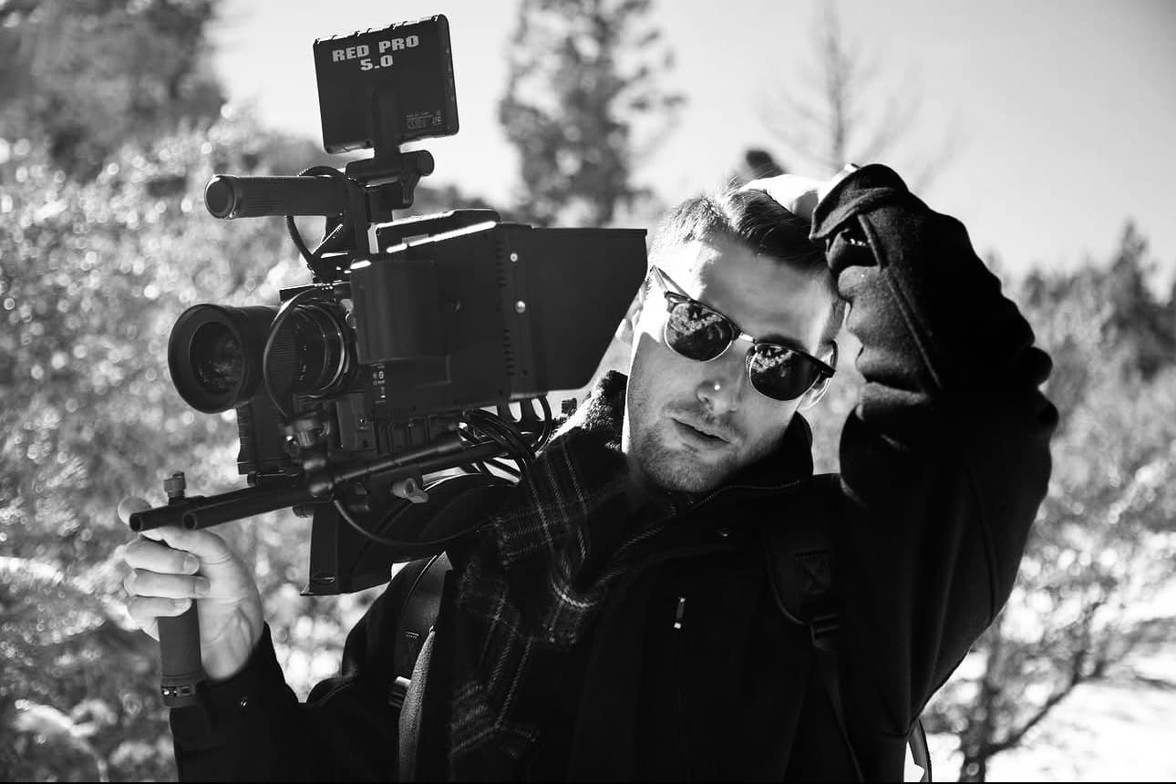 Devin Teer operating a RED Pro camera on location